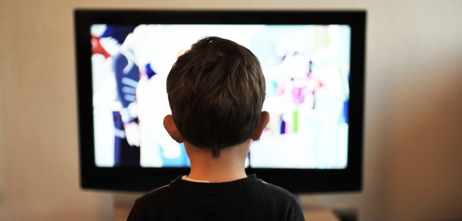 Little boy watching television