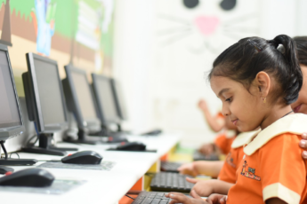A teacher guiding a child to develop digital literacy skills